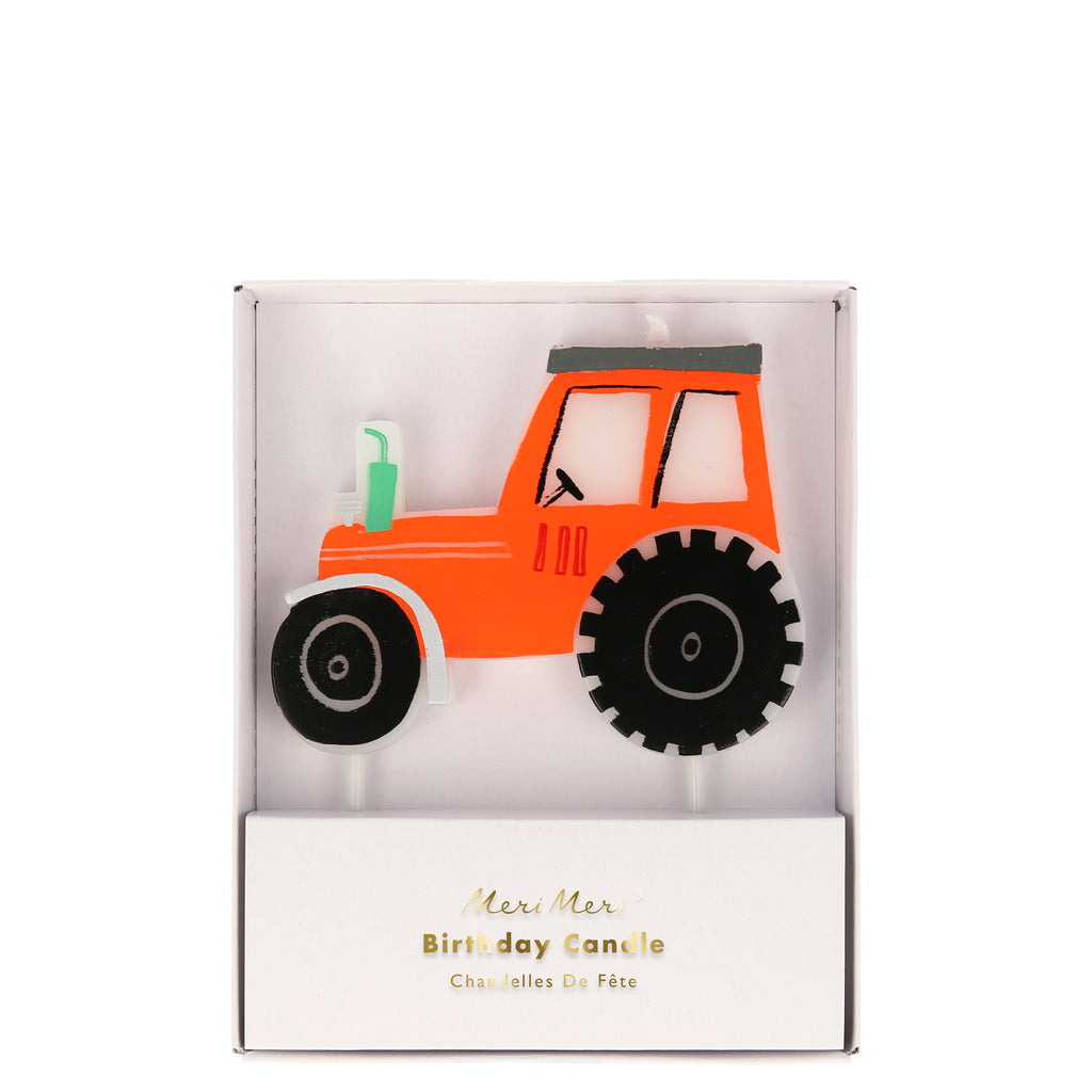 Red tractor candle with black tires in a box labelled Meri Meri Birthday Candle