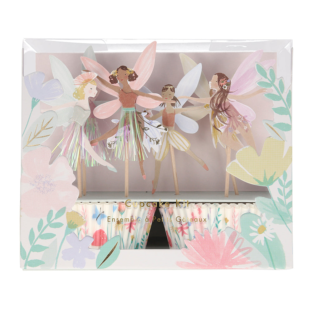 fairy cupcake kit box shows flower cupcake liners and paper fairies on toothpicks in 4 designs. The box has flowers around the edge so you can see in through plastic.
